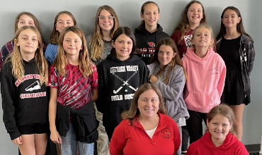 group of 6th and 7th grade girls and teacher