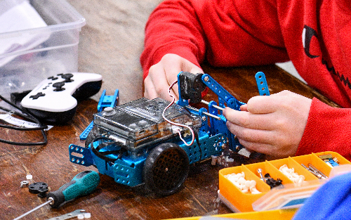 Robotics student working on a robot