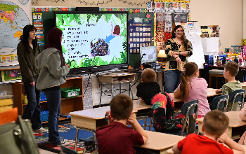 Students giving a presentation to elementary schoolers