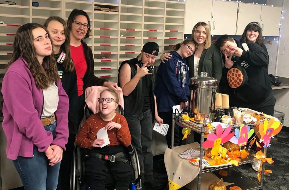 students in mrs. meisters class posing for a photo next to the HS coffee cart