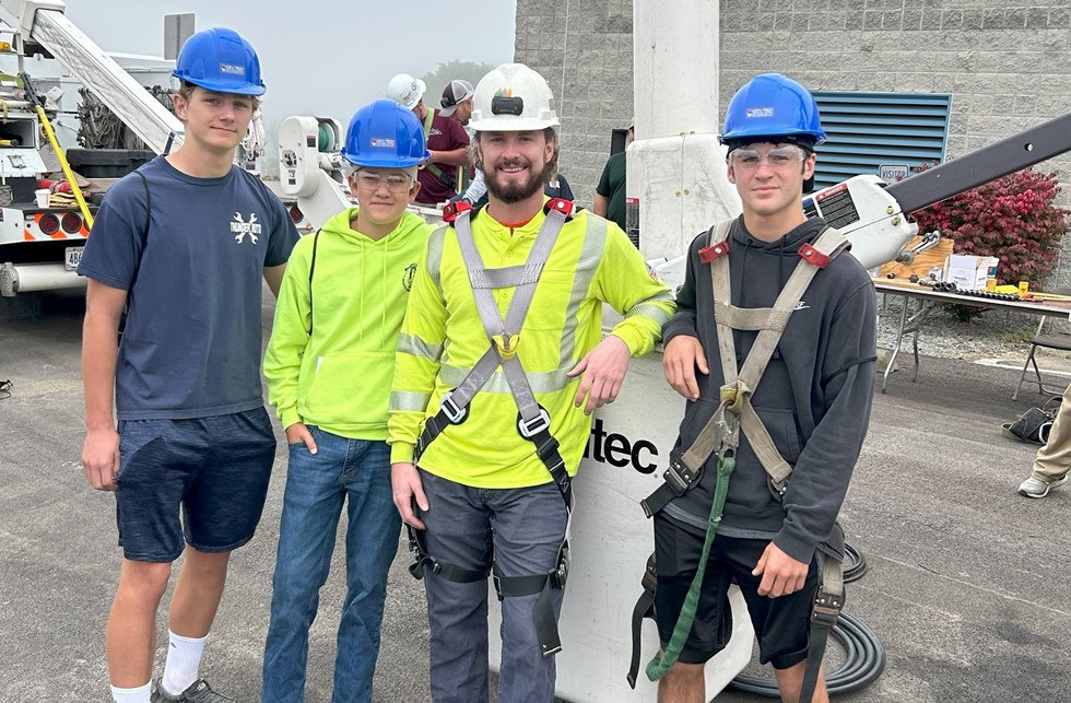 Students with a NYSEG electrician to learn more about the field