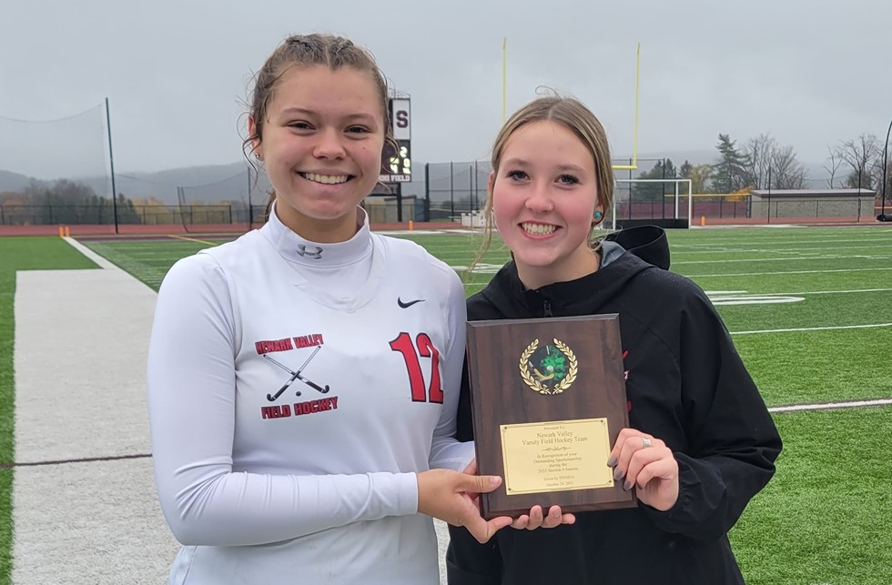 Two students holding the field hockey sportmanship award