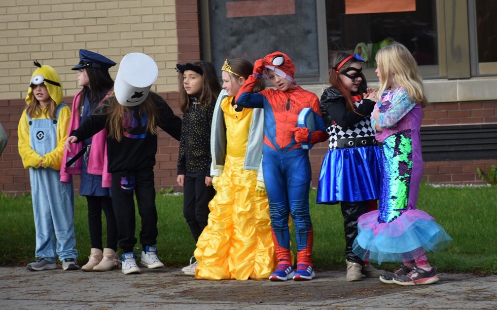 students in costume waiting in line and talking