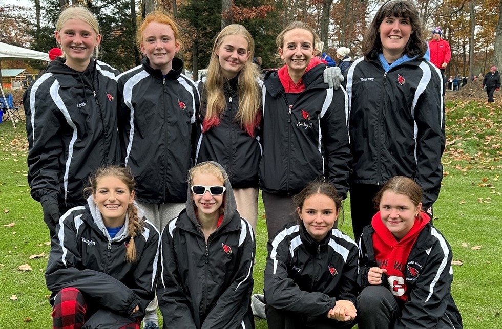 girls cross country team smiling for a photo
