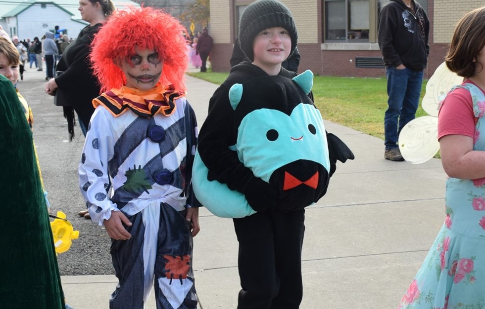 two students in halloween costumes smiling at the camera