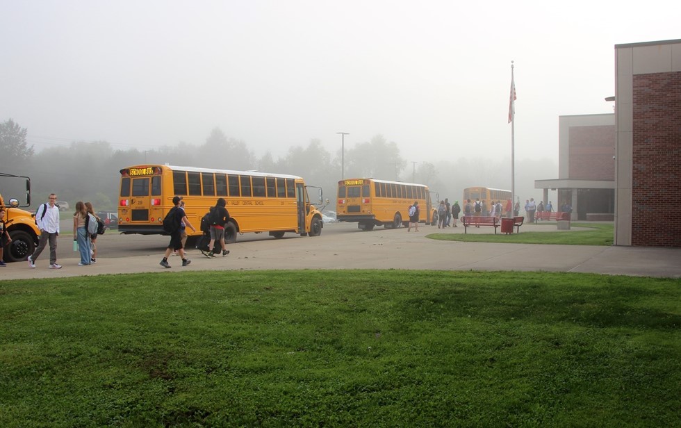 School buses and students in front of high school