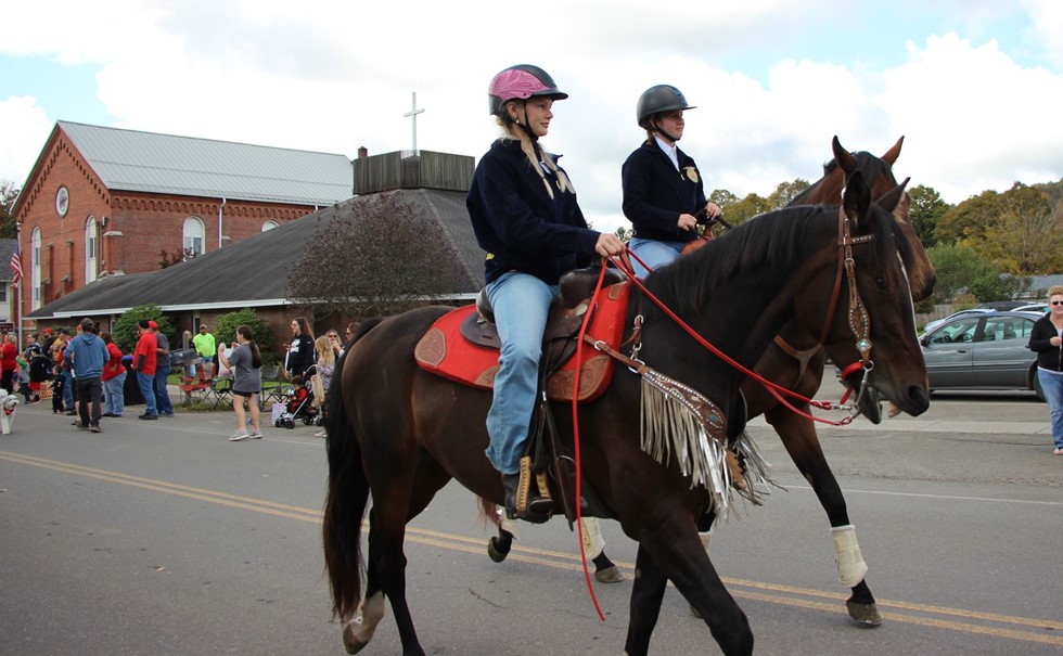 Two students on horseback in parade