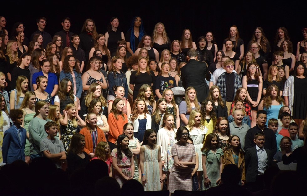 Group of students singing in a chorus concert 