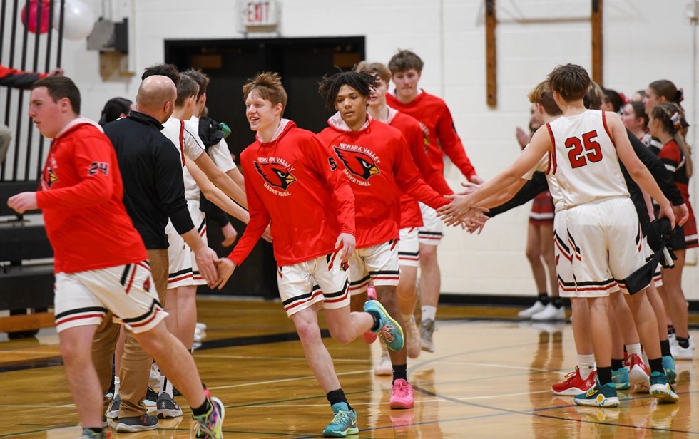 Basketball players run into gym
