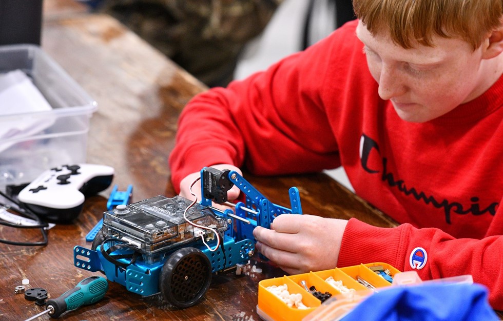 Robotics student working on robot
